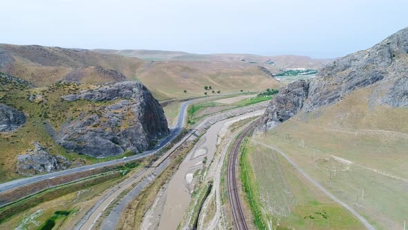 mountain landscape over road, river and railway