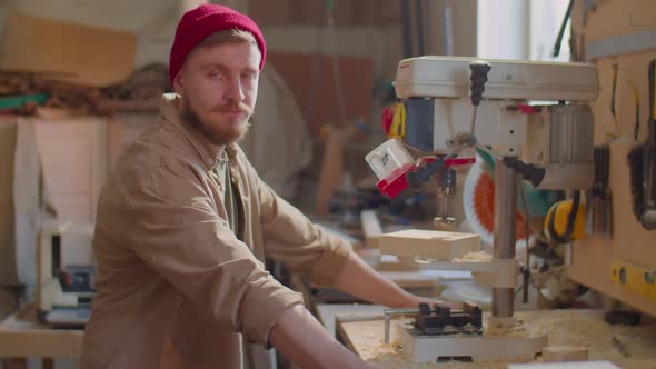 Portrait of Cheerful Woodworker in Carpentry Workshop