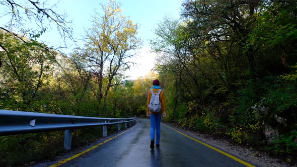 Pretty Smiling Asian Woman Walks in Autumn Woods