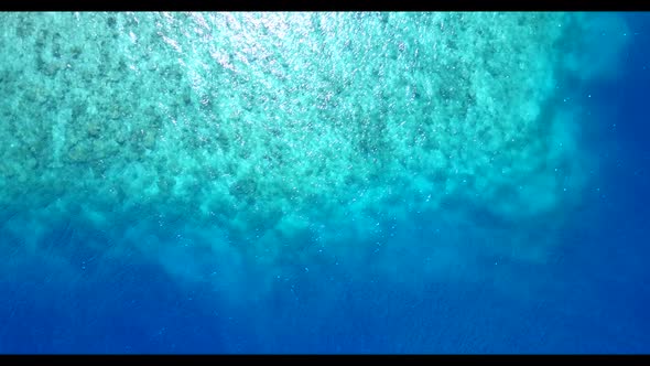 Aerial drone seascape of idyllic seashore beach journey by turquoise sea with white sand background 