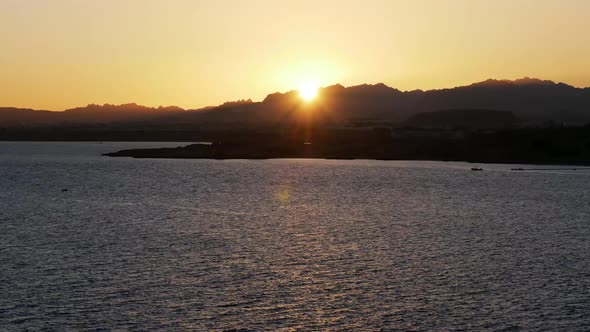 Timelapse of Romantic Sunset on the Sea. Sun Going Down Over Horizon with Mountains at Sunset