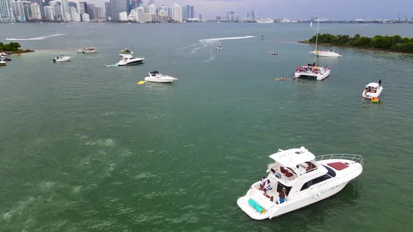 Yachts and Sailboats in Boat Harbor on City Skyline Coast of Miami, Florida - Aerial