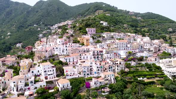 Aerial shot pan right of an Italian village in Amalfi coast, in a mountain landscape