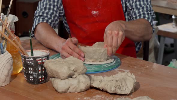 Male Potter Making Ceramic Bowl at His Workshop