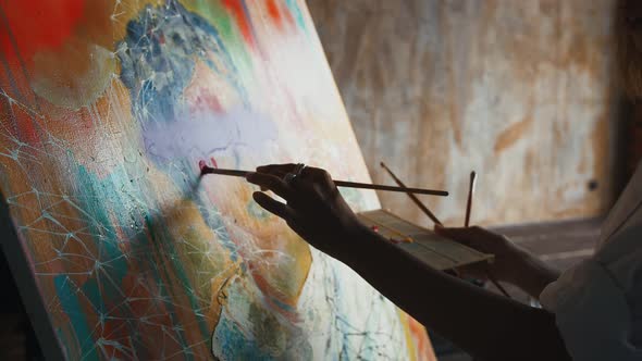 Unknown Woman Artist is Painting a Portrait on Canvas in Concept Art Style While Working in Bedroom