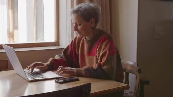 Senior woman relaxing alone at home