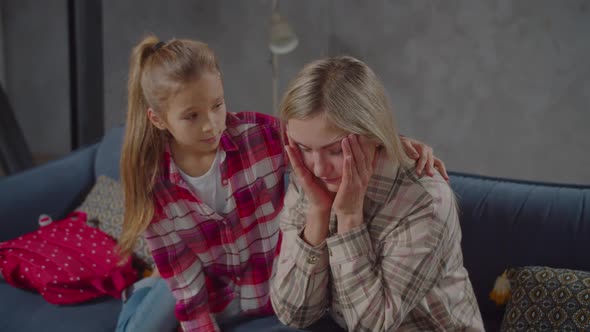 Loving Daughter Consoling Upset Mom on Couch