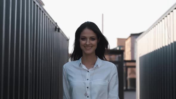 Attractive Girl of European Appearance Walks Down the Street Smiling