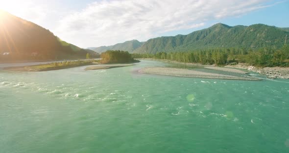 Low Altitude Flight Over Fresh Fast Mountain River with Rocks at Sunny Summer Morning