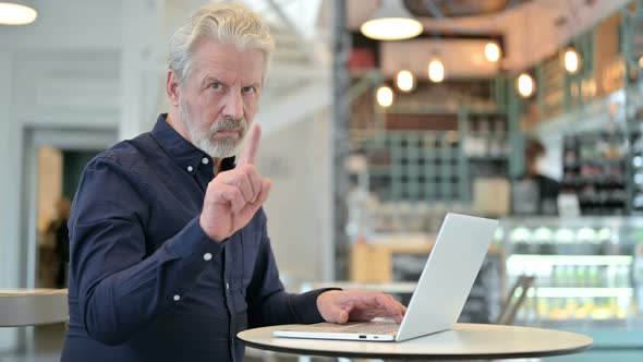 No, Finger Gesture By Old Man with Laptop in Cafe