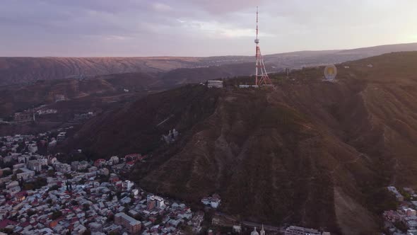 Transmit Mast Over The City At Sunset