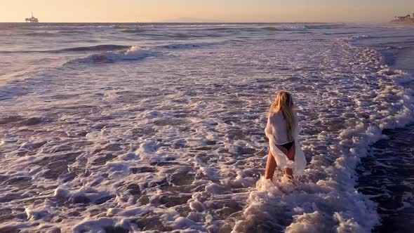 Attractive Blond Woman Walking on the Beach