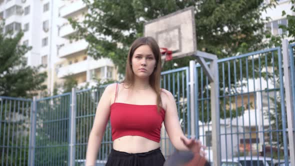 Young Attractive Woman on a Basketball Court Outdoors