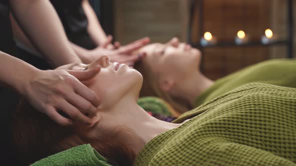 Two Redhead Ladies Lie on Bed Relaxing After Spa Treatment Massage