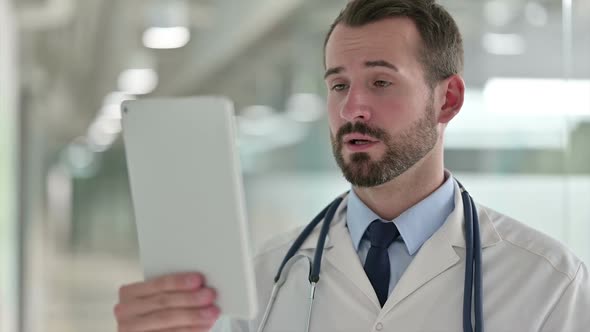 Portrait of Male Doctor Doing Video Call on Digital Tablet