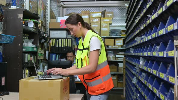 Warehouse Manager and female warehouse clerk counting the small parts stored