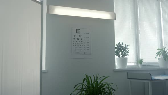 Standard Eyesight Test Chart Hanging White Wall in Doctor Office Close Up