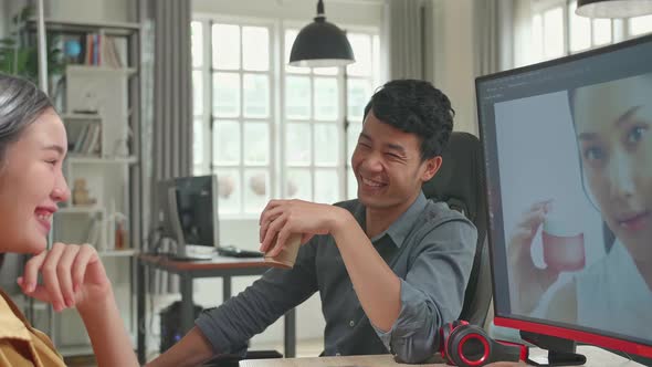 Happy Asian Male And Female Professional Editors Talking While Working In Photo Editing On Computer