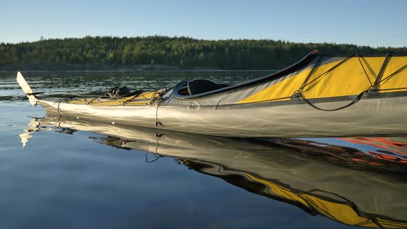 Yellow Sports Kayak on Water Near Bank of Tranquil Lake