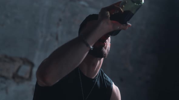 Man drinking wine alone in a dark room