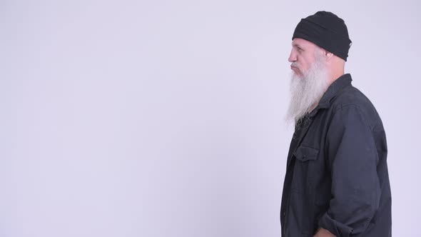 Profile View of Mature Bearded Hipster Man Thinking