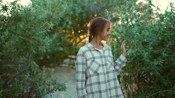 Slow Motion Portrait of Carefree Attractive Mixed Race Woman Enjoying Walk Outdoors in Green Bushes