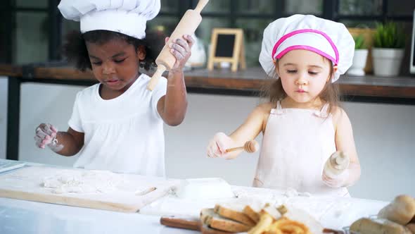 Diverse Group of Girls Prepare the Dough and Bake Cookies in the Kitchen