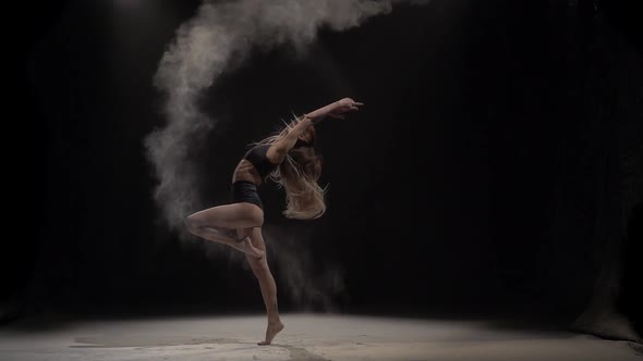 Female Throwing Dust Particles in Air at Studio. Slow Motion