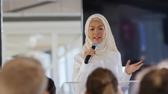 Speaker addressing the audience at a business conference