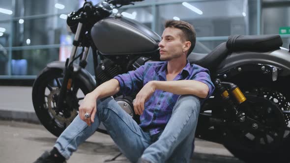 Portrait of Young Attractive Man Motorcyclist on Night Street