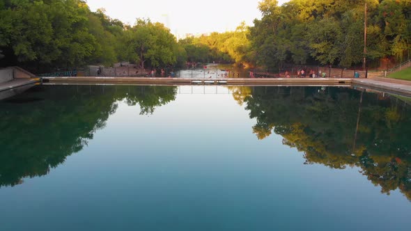 Quick pan up from barton springs pool, down barton creek, revealing downtown Austin Texas