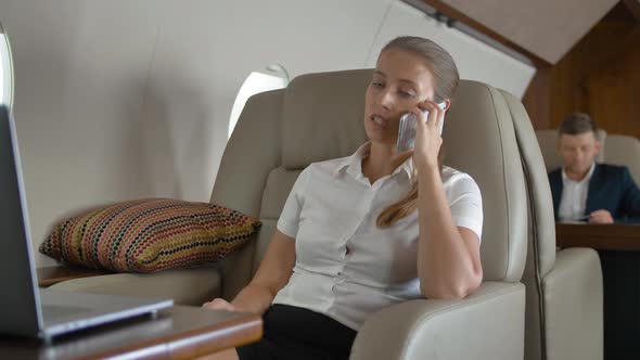 Private Jet Flight of Businesslady Speaking About Business