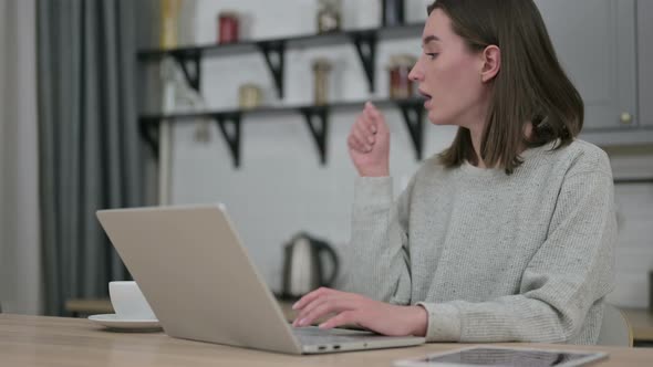 Sick Young Woman Working on Laptop and Coughing 