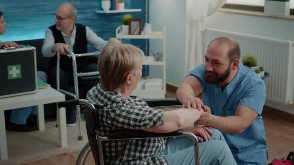 Aged Woman with Handicap Getting Support From Nurse