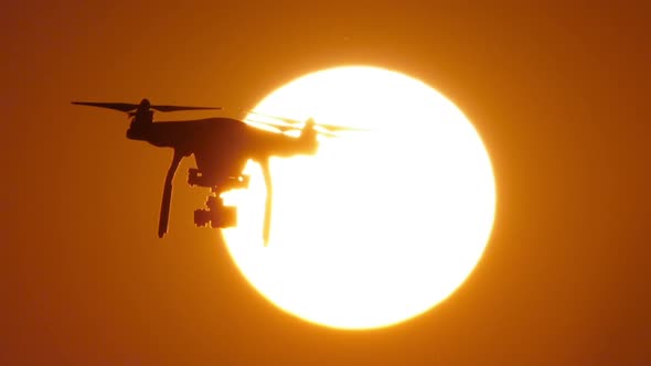 HD - Quadcopter drone on background of the Sun