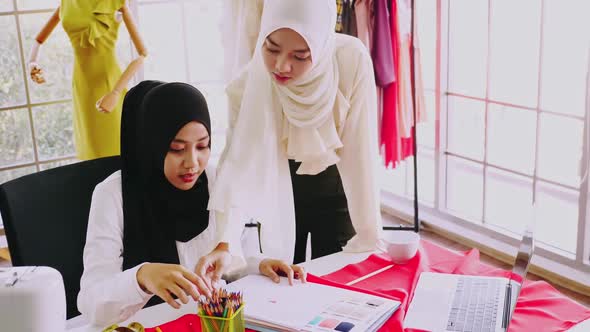 Muslim women fashion designers are in process of creating new clothes collection.