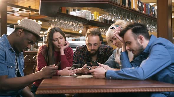 Unhappy, Boring Group of Friends Using Smart Phone