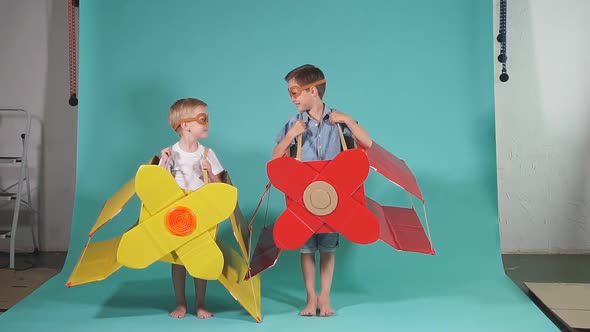 Little Children in Toy Airplane Against Blue Background