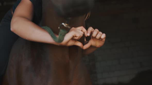 Horsewoman Holding Her Dark Bay Horse With Love  Making A Heart With Her Fingers