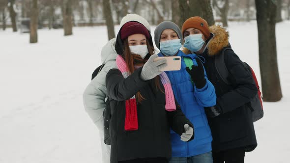 Happy Friends Classmates Wearing Masks Taking Selfie Photo on Smartphone