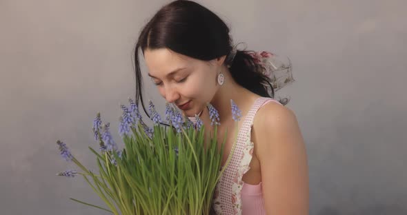 Woman Holding Bouquet of Flowers in Hands Indoors