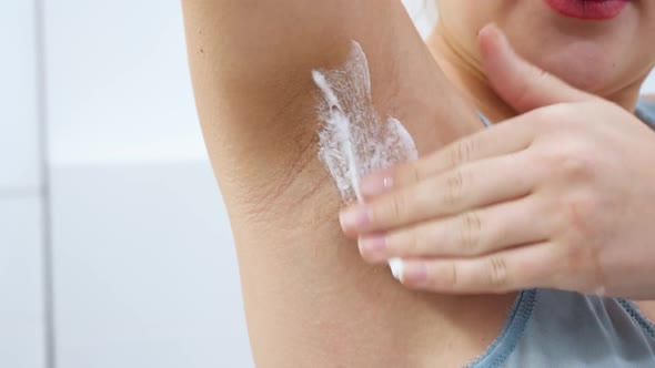 Closeup of Young Woman with Natural Hairy Armpits Applying Shaving Cream Before Removing Hair or