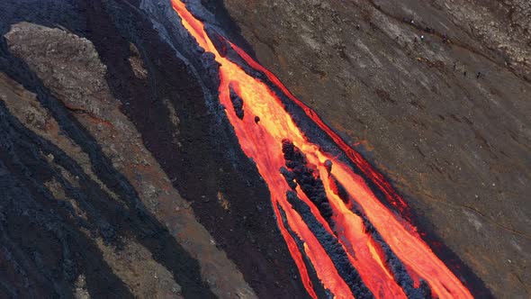 Huge Lava stream Flowing down the hill and Tourists lining up to see it, near Fagradalsfjall Volcano