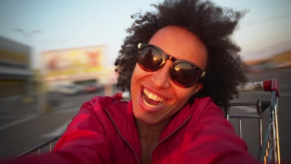 African American Girl with Curly Hair Making Selfie Video While Caucasian Bearded Man Circling Her