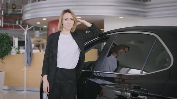 Portrait of an Elegant Business Lady in a New Car Dealership