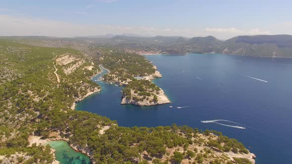 Aerial travel drone view of clear green water, cliffs of Cassis, Mediterranean Sea, Southern France.