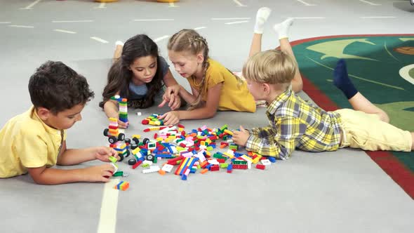 Four Kids Play with Blocks