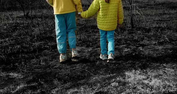 The younger sisters, dressed in the colors of the Ukrainian flag holding hands