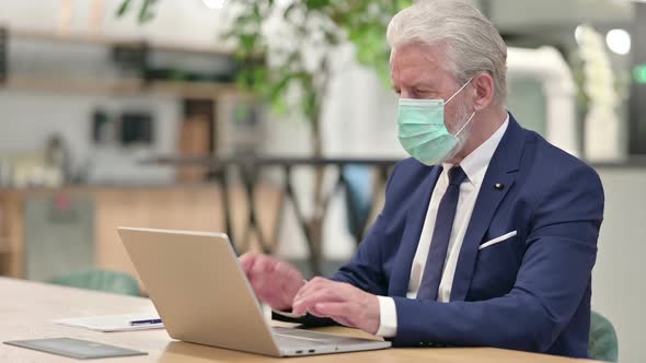 Senior Old Businessman with Face Mask Celebrating on Laptop