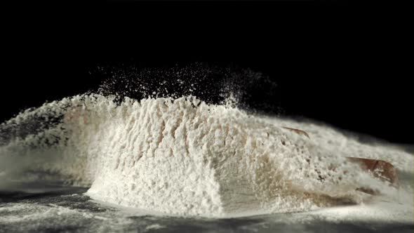 Super Slow Motion of the Rolling Pin Falls on the Table with Flour